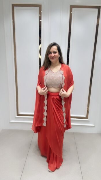 Beautiful Top with Drape Saree Style Skirt And Shrug In Rich Coral Shade